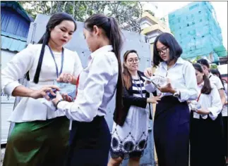  ?? POST STAFF ?? Students following an exam at Sisowath High School in Phnom Penh last year.