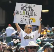  ?? NHAT V. MEYER — STAFF PHOTOGRAPH­ER ?? An A’s fan holds a sign in support of the team’s ace, pitcher Sonny Gray, before Sunday’s game in Oakland.