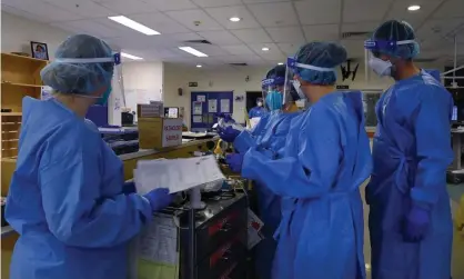  ?? Photograph: Kate Geraghty/The Sydney Morning ?? ICU staff care for Covid-19 positive patients in St Vincent’s hospital in Sydney in July 2021. As of 9 January the share of staffed ICU beds occupied by Covid patients in NSW stood at 33%, up from 19.9% on 2 January.