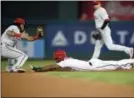  ?? NICK WASS — THE ASSOCIATED PRESS ?? Washington’s Michael Taylor, right, steals second against Phillies shortstop Freddy Galvis, left, during the second inning Thursday in Washington.