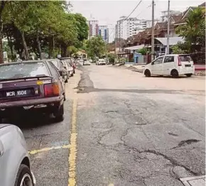  ??  ?? The poorly patched up road near the Pantai Hillpark apartments. PIC COURTESY OF READER