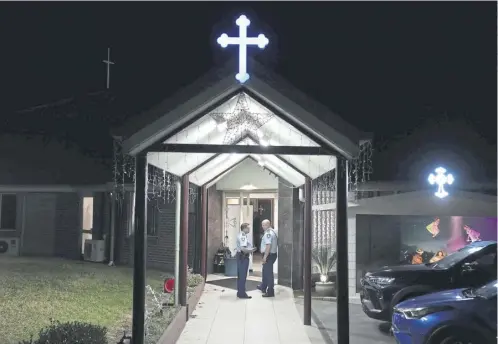  ?? ?? Security officers stand guard outside Orthodox Assyrian church in Sydney where Bishop Mar Mari Emmanuel, below, was stabbed