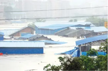  ??  ?? A general view of a flooded street in Loudi, Hunan province. — AFP photo