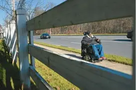  ?? LLOYD FOX/STAFF PHOTOS ?? Walter Smith, 60, uses his wheelchair to head to the grocery store near his home in Owings Mills. Smith has been paralyzed since he was shot in Annapolis in 2020.