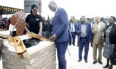  ??  ?? Mr Mutati unveils a plaque for commission­ing the constructi­on of Tobacco Industrial Pack for Roland Imperial tobacco company Limited