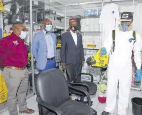  ?? (Photos: Aston Spaulding) ?? From left: Oral Richards, MMS business consultant and divisional director, Hugh Graham, CEO and managing director of Paramount Jamaica Ltd, Lloyd Distant, president of the Jamaica Chamber of Commerce. observing a demonstrat­ion of the Ryobi Electrosta­tic fogging machine used for sanitizing and general cleaning