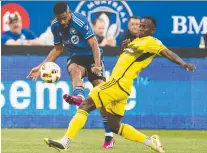  ?? CHRISTINNE MUSCHI/THE CANADIAN PRESS FILES ?? CF Montréal defender Ruan, left, advances the ball against Columbus Crew midfielder Yaw Yeboah during match on Wednesday at Saputo Stadium.