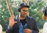  ??  ?? Writer-director Jordan Peele on the set. Above: Rose (Allison Williams) brings boyfriend Chris (Daniel Kaluuya) to her parents’ country estate in “Get Out.” At left: writer-director Jordan Peele.