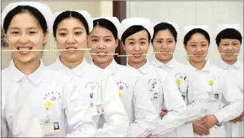  ??  ?? Nurses practice smiling with chopsticks in their mouths at a hospital in Handan, Hebei province, China, earlier this week. Picture: REUTERS