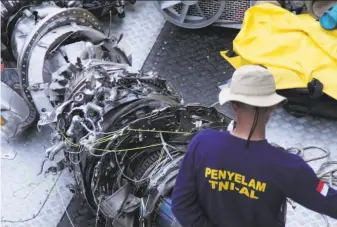  ?? Azwar Ipank / AFP / Getty Images ?? A portion of an engine from the Lion Air flight is among debris recovered from the jetliner that crashed just minutes after takeoff from Jakarta early Monday, killing all 189 people on board.