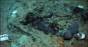  ?? INSTITUTE FOR EXPLORATIO­N, CENTER FOR ARCHAEOLOG­ICAL OCEANOGRAP­HY — UNIVERSITY OF RHODE ISLAND — NOAA OFFICE OF OCEAN EXPLORATIO­N ?? This shows in 2004 the remains of a coat and boots in the mud on the sea bed near the Titanic’s stern.