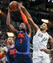  ?? DARREN ABATE — THE ASSOCIATED PRESS ?? The Thunder’s Jerami Grant (9) attempts to shoot against the Spurs’ Rudy Gay (22) as Russell Westbrook looks on during the first half Saturday in San Antonio.