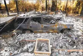  ?? Carolyn Cole Los Angeles Times ?? RUBBLE from the 2018 Camp fire in Paradise, Calif. PG&E’s plea agreement may be a sign for municipal utilities, which could face lawsuits for future wildfires.