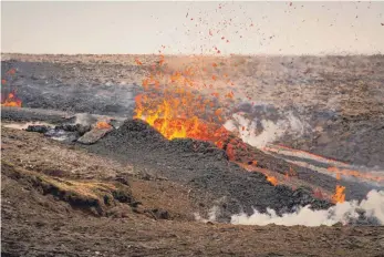  ?? FOTO: MARCO DI MARCO/DPA ?? Lava spritzt aus einer neuen Felsspalte auf einem Vulkan. Wegen einer neuen, rund 500 Meter langen Felsspalte hat es an dem auf Island seit Wochen sprudelnde­n Vulkan einen größeren Polizeiein­satz gegeben.