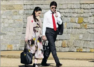  ?? CP PHOTO ?? Canadian Prime Minister Justin Trudeau walks with New Zealand Prime Minister Jacinda Ardern as they arrive at Windsor Castle for the leaders’ retreat at the Commonweal­th Heads of Government Meeting in Windsor, Great Britain, Friday.