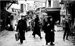  ?? HASSAN AMMAR/AP ?? Syrians walk Sunday in a market in the Old City of Damascus. Some in the Trump administra­tion painted last week’s strike as a possible portent of greater U.S. involvemen­t in Syria.