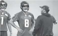  ?? Jim Mone/Associated Press ?? ■ Minnesota Vikings quarterbac­k Kirk Cousins (8) listens to instructio­ns from quarterbac­k coach Kevin Stefanski during practice Wednesday at the NFL football team’s training camp in Eagan, Minn.