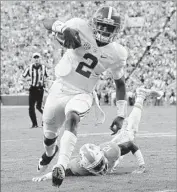  ?? Kevin C. Cox Getty Images ?? JALEN HURTS of Alabama shakes off a Tennessee defender and scores a touchdown Saturday.