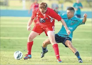  ?? Photo: PHOTOTEK ?? Charging forward: Waitakere City’s Sam Redwood is challenged by Three Kings United’s Mikhail Bredeveldt in the Northern Region Football League Premier Division match.