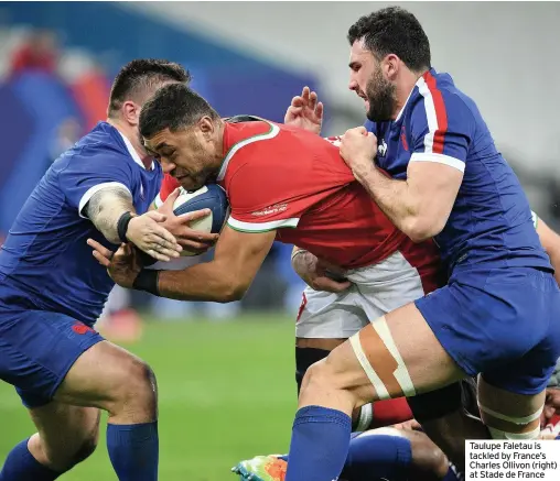  ??  ?? Taulupe Faletau is tackled by France’s Charles Ollivon (right) at Stade de France