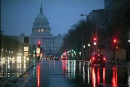  ?? J. SCOTT APPLEWHITE — THE ASSOCIATED PRESS FILE ?? In this file photo, The U.S. Capitol is seen in the distance as rain falls on Pennsylvan­ia Avenue in Washington. Why are Republican­s struggling mightily to reach a consensus on how to overhaul the nation’s tax system? The GOP is supposed to be really...