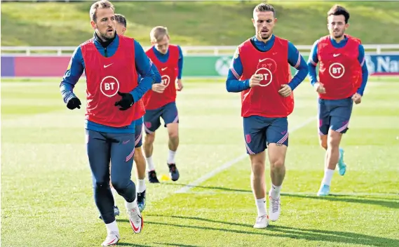  ?? ?? Run-in: Harry Kane (left) leads England in training with Jordan Henderson yesterday