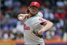  ?? SETH WENIG — THE ASSOCIATED PRESS ?? Philadelph­ia Phillies starting pitcher Aaron Nola throws during the first inning of a baseball game against the New York Mets at Citi Field, Sunday in New York.