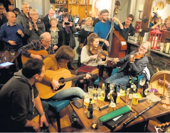  ??  ?? Centre of the sound
Dougie MacLean enjoys a pub session during a previous Perthshire Amber festival