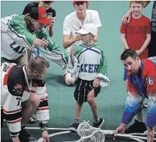  ?? CLIFFORD SKARSTEDT EXAMINER ?? Five-year-old Nolan Grandel, who has cerebral palsy, takes part in a pre-game faceoff as Peterborou­gh Century 21 Lakers host the Brooklin Redmen before Game 1 of the Major Series Lacrosse semifinal series at the Memorial Centre on Thursday.