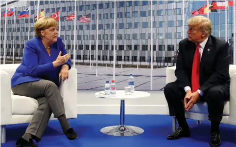  ?? (Kevin Lamarque/Reuters) ?? US PRESIDENT Donald Trump meets with German Chancellor Angela Merkel yesterday during the NATO summit in Brussels.