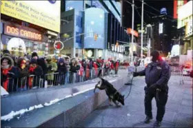  ?? GO NAKAMURA — THE ASSOCIATED PRESS FILE ?? A police K-9 unit patrols in New York’s Times Square where crowds were gathered for the annual New Year’s Eve celebratio­n. The New York Police Department is adding a drone this year to the security forces it uses to protect the huge crowds celebratin­g New Year’s Eve in the city.