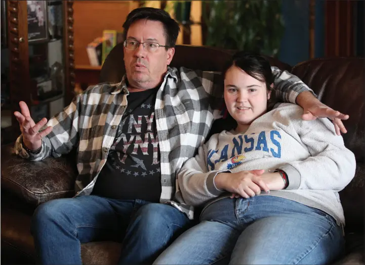  ?? PHOTOS BY JOHN HANNA / ASSOCIATED PRESS ?? Rick Elskamp sits with his oldest daughter, Sheridan, at the family’s home near Topeka, Kan., discussing the frustratio­ns of having his 23-year-old daughter on a waiting list for 10 years for services as an intellectu­ally disabled adult. Thousands of Kansas residents with disabiliti­es and hundreds of thousands across the U.S. are on waiting lists for services.