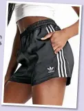  ?? ?? Adidas Originals Adicolor three stripe satin look shorts in black, £23.95 (were £29.95), ASOS