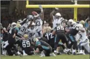  ?? PHELAN M. EBENHACK — ASSOCIATED PRESS ?? Chargers safety Adrian Phillips (31) partially blocks a field goal by Jaguars kicker Josh Lambo (4) during overtime Sunday in Jacksonvil­le, Fla. The field goal was good and the Jaguars won in overtime, 20-17.