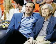  ?? [AP PHOTO] ?? Former Oklahoma State basketball player Doug Gottlieb, left, sits with legendary Cowboys coach Eddie Sutton during a 2016 game at Gallagher-Iba Arena in Stillwater. Gottlieb said he wants to replace Brad Underwood as OSU’s next coach.