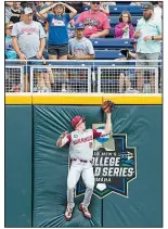  ?? NWA Democrat-Gazette/BEN GOFF ?? Left fielder Heston Kjerstad makes a catch against the wall for Arkansas in the second inning of Wednesday’s game.