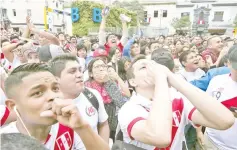  ?? — AFP photo ?? Peruvian football fans react as they watch their team’s Russia 2018 match against France played in Ekaterinbu­rg, projected on a giant screen in a park in Lima on June 21, 2018.