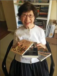  ?? PEG DEGRASSA — DIGITAL FIRST MEDIA ?? Author Annabel Liu displays the trilogy of books that she has written in English. The books, available through Amazon.com, are witty and contemplat­ive collection­s of literary essays and short stories reflecting upon her travels, family and life...