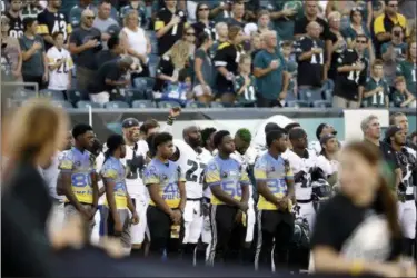  ?? MATT ROURKE — THE ASSOCIATED PRESS ?? Eagles’ Malcolm Jenkins, center left, raises his fist during the national anthem.