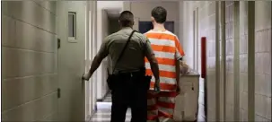  ??  ?? In this 2013 file photo, an inmate at the Madera County Jail is taken to a housing unit at the facility in Madera
AP PHOTO/RICH PEdRONCEll­I