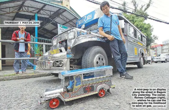  ?? ANDY ZAPATA JR. ?? A mini-jeep is on display along the street in Baguio City yesterday. The owner, Romeo Catbagan (right), wishes he can use the mini-jeep for his livelihood to save on gas.