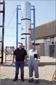  ?? NEWS PHOTO EMMA BENNETT ?? VP finance Mark Brown and PureJet Technician Chris Arnold stand Friday next to the PureJet 200 at their shop. Atlantis Research Labs has won funding from the Alberta Emissions Reduction Agency for its methane-reduction system. The system burns methane...