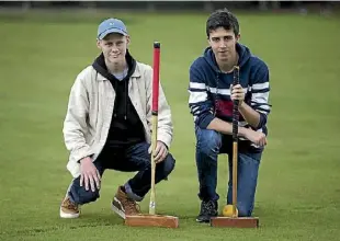  ??  ?? Cameron Main, 16, and Jayden Yeoman, 17, from the Hamilton Boys’ High croquet team, competing in the national secondary schools competitio­n.