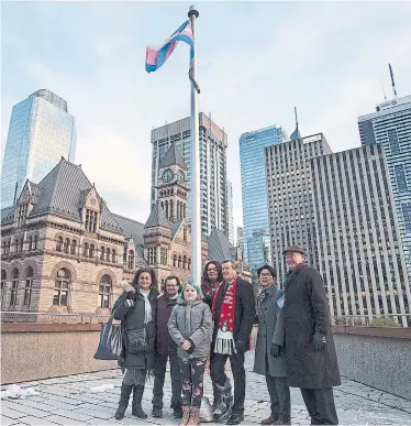  ?? ANDREW FRANCIS WALLACE TORONTO STAR ?? Mayor John Tory, councillor­s and transgende­r activists raise the flag for the Transgende­r Day of Remembranc­e.