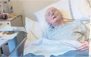  ??  ?? Mr John Gibbs in his hospital bed at Ysbyty Gwynedd