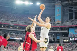  ?? BOB DONNAN • USA TODAY SPORTS ?? Purdue Boilermake­rs centre Zach Edey shoots the ball against North Carolina State Wolfpack forward Ben Middlebroo­ks during the second half in the semifinals of the men’s Final Four of the 2024 NCAA Tournament at State Farm Stadium.