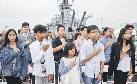  ?? Photograph­s by Christian K. Lee Los Angeles Times ?? CHILDREN ARE SWORN IN as citizens aboard the battleship Iowa during one of two L.A. events where Sen. Kamala Harris spoke.