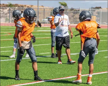  ?? Cory Rubin/The Signal (See additional photos on signalscv.com) ?? Castaic head coach Tony Uebelhardt coaches the corners and wide receivers at practice at Castaic High School Thursday afternoon. The Coyotes freshman team has its first game at West Ranch on Thursday.