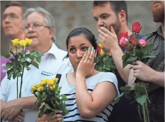  ??  ?? DAN KITWOOD, GETTY IMAGES People attend a vigil outside Finsbury Park Mosque on Monday in London. Worshipers leaving the mosque after Ramadan prayers were struck by a van the night before.