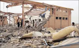  ??  ?? People inspect damage at a Doctors Without Borders medical facility after it was hit by an air strike in Abss, Yemen, on Monday.